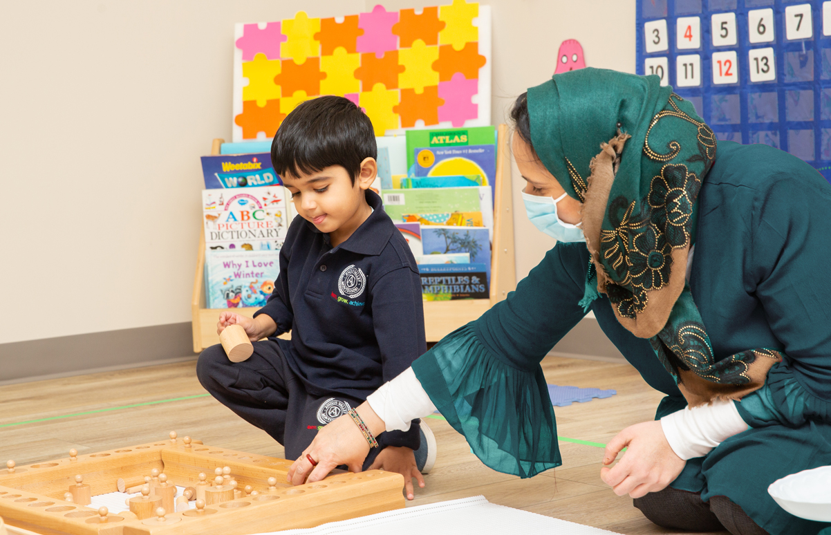 Montessori teacher working with child